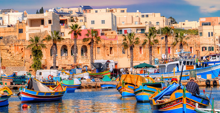 Marsaxlokk village port of Malta, illuminate by sunset light, European travel in beautiful place